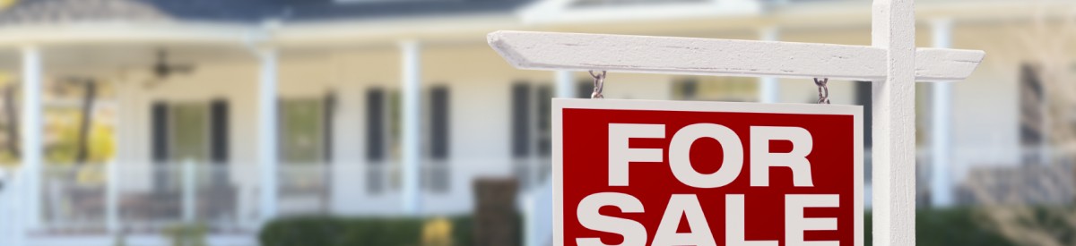 Home For Sale Real Estate Sign in Front of Beautiful New House.